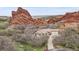 Secluded home with tile roof situated amongst mature trees and monumental red rock formations creates a natural hideaway at 5688 Red Fern Ct, Littleton, CO 80125
