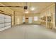 Spacious garage with primed walls, concrete floor and utility sink at 5688 Red Fern Ct, Littleton, CO 80125