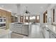 Spacious modern kitchen with high-end appliances, a large island, natural lighting, and scenic outdoor views at 5688 Red Fern Ct, Littleton, CO 80125