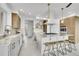 Beautiful modern kitchen featuring a large island, stone countertops, stainless steel appliances, and wood cabinets at 5688 Red Fern Ct, Littleton, CO 80125