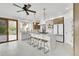 Bright, open kitchen with large island, pendant lighting, modern appliances, and seamless access to the outdoors at 5688 Red Fern Ct, Littleton, CO 80125