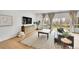 Bright living room with hardwood floors, large windows, and comfortable furniture at 5688 Red Fern Ct, Littleton, CO 80125