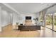 Modern living room with hardwood floors, comfortable seating, and backyard views at 5688 Red Fern Ct, Littleton, CO 80125