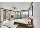 Spacious main bedroom features a cozy fireplace, comfortable sitting area, and ample natural light at 5688 Red Fern Ct, Littleton, CO 80125