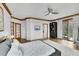 Serene main bedroom features hardwood floors, neutral decor, and a private balcony with natural light at 5688 Red Fern Ct, Littleton, CO 80125