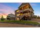 Multi-tiered deck and manicured backyard perfect for entertaining, complete with stone patio and stairs at 16262 W 95Th Ln, Arvada, CO 80007