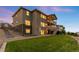 Spacious backyard featuring lush green lawn, stone accents and retaining walls, and a tiered deck at 16262 W 95Th Ln, Arvada, CO 80007