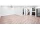 Open basement living area featuring wood-look floors, recessed lighting, and access to additional rooms at 16262 W 95Th Ln, Arvada, CO 80007
