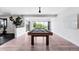 Finished basement with a pool table, ample natural light, and access to outdoor space at 16262 W 95Th Ln, Arvada, CO 80007