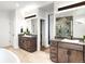 Luxurious bathroom featuring dual sinks, modern vanity, and a walk-in shower at 16262 W 95Th Ln, Arvada, CO 80007