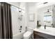 Bright bathroom with white subway tile, shower-tub combo, and a stylish vanity with modern fixtures at 16262 W 95Th Ln, Arvada, CO 80007