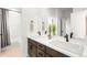 Bathroom featuring a double vanity with contemporary sinks, modern fixtures, and a large mirror at 16262 W 95Th Ln, Arvada, CO 80007