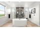 Spa-like bathroom with a freestanding tub, walk-in shower, and modern fixtures at 16262 W 95Th Ln, Arvada, CO 80007