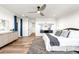 Stylish bedroom featuring an accent wall, hardwood floors, and modern decor at 16262 W 95Th Ln, Arvada, CO 80007