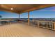 Covered patio showcasing an expansive view of the neighborhood and scenic landscape at 16262 W 95Th Ln, Arvada, CO 80007