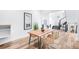 Open-concept dining room with a rustic wooden table and stylish wicker chairs at 16262 W 95Th Ln, Arvada, CO 80007