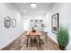 Bright dining room featuring a rustic wood table and elegant decor at 16262 W 95Th Ln, Arvada, CO 80007