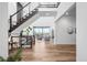 Grand entryway boasts high ceilings, modern staircase, and beautiful hardwood floors at 16262 W 95Th Ln, Arvada, CO 80007
