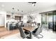 Open-concept kitchen and dining area with modern design and stainless steel appliances at 16262 W 95Th Ln, Arvada, CO 80007