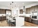 Modern kitchen boasts a large island, stainless steel appliances, and stylish pendant lighting at 16262 W 95Th Ln, Arvada, CO 80007