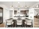 Bright kitchen features a white countertop island, stainless appliances, and elegant pendant lights at 16262 W 95Th Ln, Arvada, CO 80007