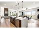 Open concept kitchen with island seating, flows into living and dining areas with great views at 16262 W 95Th Ln, Arvada, CO 80007