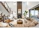 Bright living room featuring fireplace, comfortable seating, and large windows at 16262 W 95Th Ln, Arvada, CO 80007