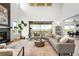 Spacious living room with a fireplace, large windows, and comfortable seating area at 16262 W 95Th Ln, Arvada, CO 80007