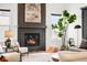 Elegant living room features a cozy fireplace and a large painting above the mantel at 16262 W 95Th Ln, Arvada, CO 80007