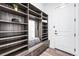 Well-organized mudroom with custom shelving, seating, and a convenient mirror at 16262 W 95Th Ln, Arvada, CO 80007