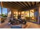 Covered outdoor deck featuring comfortable lounge seating and access to the interior at 16262 W 95Th Ln, Arvada, CO 80007