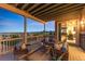 Relaxing outdoor deck features comfortable seating and scenic views at twilight at 16262 W 95Th Ln, Arvada, CO 80007
