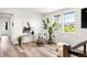 Bright sitting area featuring modern decor, hardwood floors, and natural light from large windows at 16262 W 95Th Ln, Arvada, CO 80007