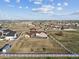 Expansive property with large house, fenced yard, and serene surroundings under a beautiful sky at 16101 Iola St, Brighton, CO 80602