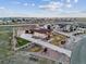 Expansive property with a modern home, white fencing, landscaping and long driveway at 16101 Iola St, Brighton, CO 80602