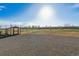 Wide open backyard with white perimeter fencing, shed, and plenty of space for outdoor activities at 16101 Iola St, Brighton, CO 80602