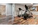 Basement exercise room with wood-look flooring and a large doorway leading to the bathroom at 16101 Iola St, Brighton, CO 80602