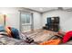 Basement living room with wooden floors, comfortable seating, and a large television at 16101 Iola St, Brighton, CO 80602