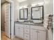 Bathroom featuring double sinks, granite countertops, mirrors and cabinet space for ample storage at 16101 Iola St, Brighton, CO 80602
