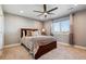 Bedroom featuring neutral colored walls, a large window, ceiling fan, and a comfortable bed at 16101 Iola St, Brighton, CO 80602