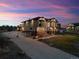 Exterior dusk view of a two-story home with a long driveway and manicured front yard at 16101 Iola St, Brighton, CO 80602