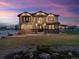 Exterior dusk view of a two-story home with manicured front yard at 16101 Iola St, Brighton, CO 80602