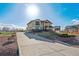 Stunning exterior featuring a spacious driveway, manicured lawn, and elegant architectural details at 16101 Iola St, Brighton, CO 80602