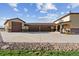 Exterior elevation featuring a three-car garage and beige stucco at 16101 Iola St, Brighton, CO 80602