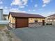 Exterior elevation features a one-car garage and beige stucco at 16101 Iola St, Brighton, CO 80602
