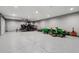 Spacious garage with epoxy flooring and lots of storage space for equipment and vehicles at 16101 Iola St, Brighton, CO 80602