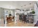 Bright kitchen featuring white cabinetry, stone accents, pendant lighting, and a breakfast bar at 16101 Iola St, Brighton, CO 80602