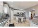 Well-lit kitchen with white cabinetry, stainless appliances, granite countertops, and tile floors at 16101 Iola St, Brighton, CO 80602