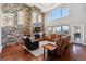 Inviting living room with a stone fireplace, high ceilings, and natural light at 16101 Iola St, Brighton, CO 80602