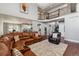 Open-concept living area with a balcony overlook, seamlessly connected to the kitchen and dining area at 16101 Iola St, Brighton, CO 80602